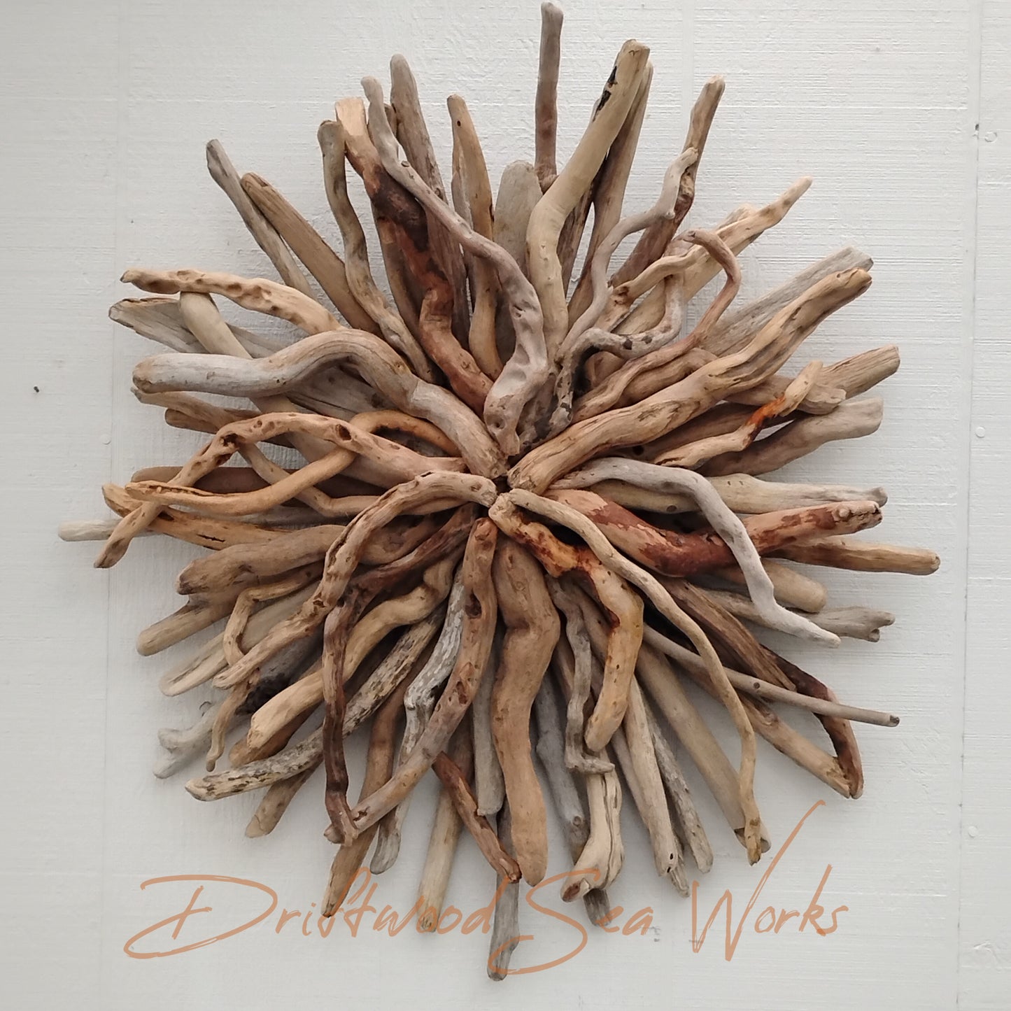 This handmade driftwood art starburst wall sculpture measures 26x 26 inches. I made it with driftwood I collected along the Oregon Coastline. All of the driftwood is natural in color and shape. This starburst is made with nails, not glue foe long lasting strength and durability. The colors of the driftwood sticks vary from cream to dark brown. There is no paint or stain on this sculpture