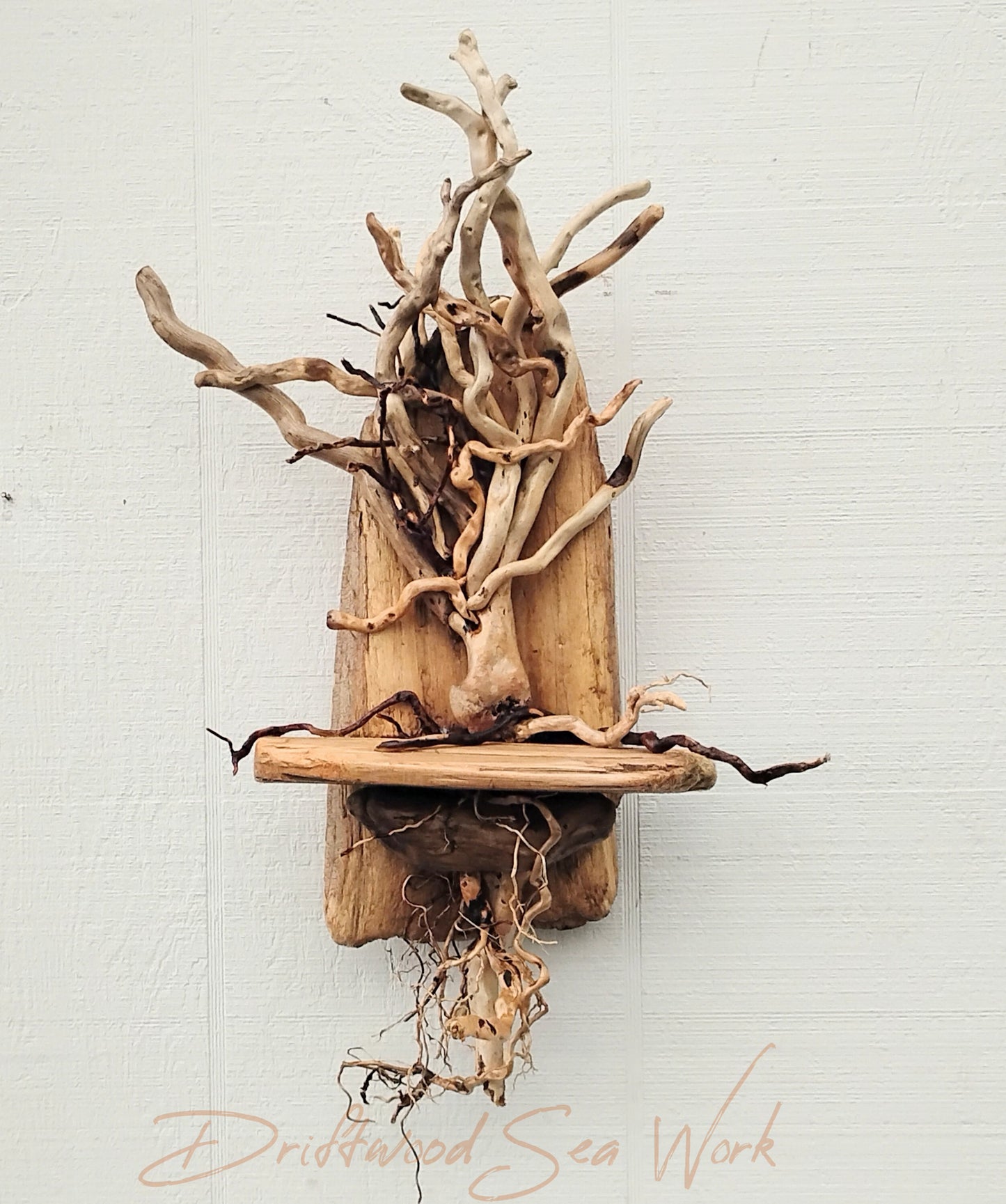 This one of a kind, unique driftwood tree was handmade by me with real driftwood pieces that I collected from the beaches of Oregon. It measures approximately 20 x 11 x 5 inches. Some pieces are naturally twisted and curved which give this piece awesome character. The branches that hang over are loose and move easily giving this piece nice movement. It is lighter in color more beige than brown which is natural to the driftwood I chose for this tree.