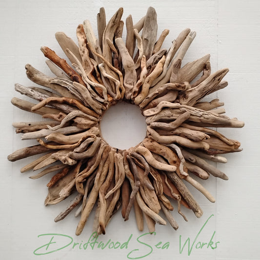 This large driftwood wreath adds a touch of rustic beach vibe to any room. Handcrafted from Oregon driftwood, the starburst design creates a unique and eye-catching focal point. Perfect for rustic or coastal decor, this wreath is a must-have for nature lovers.