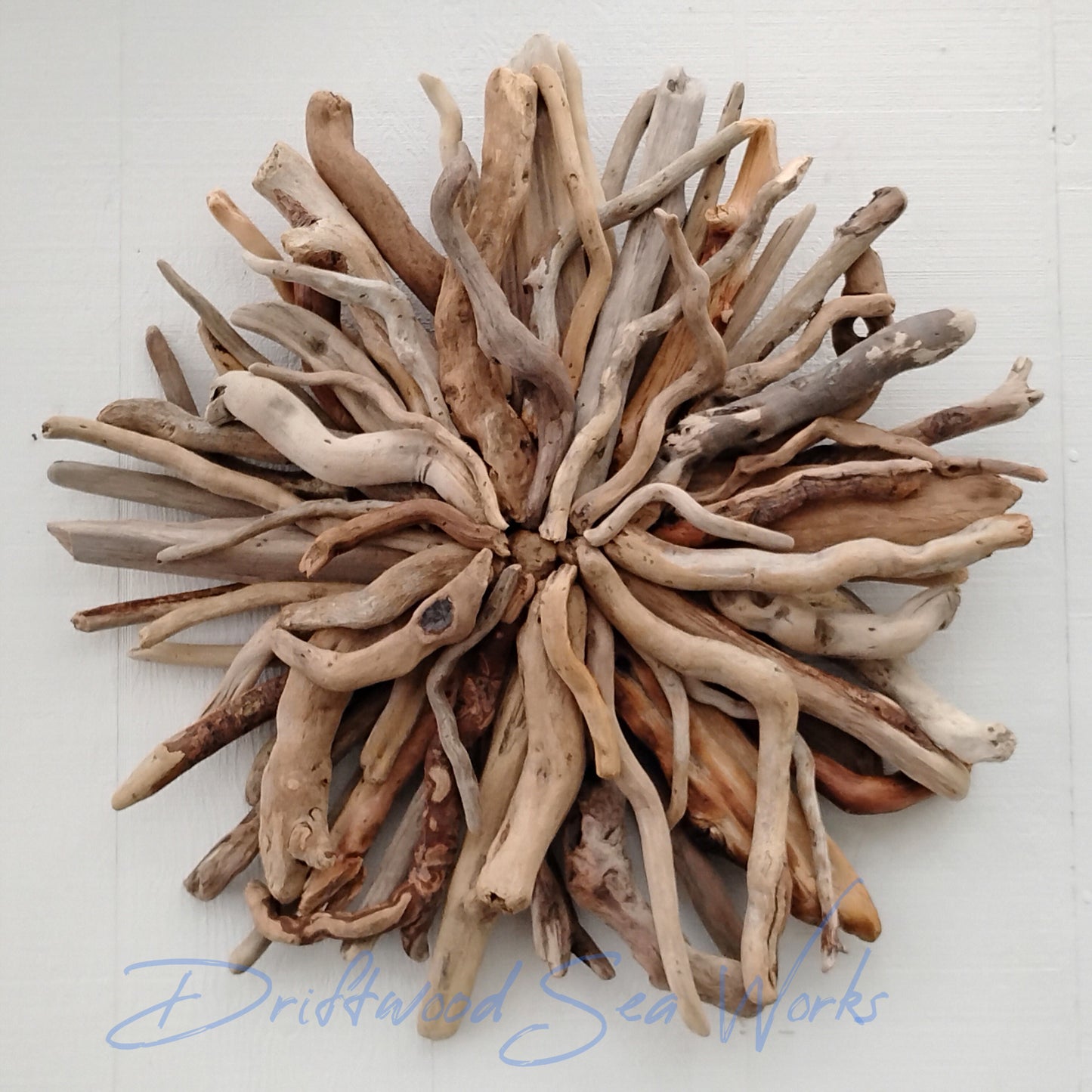 This unique and natural starburst round wall sculpture measures 27 x 27 inches. I made it with driftwood I collected along the beaches of Oregon.
Each Driftwood sculpture is unique and hand made with hand selected driftwood pieces attached one piece at a time using nails for long lasting strength and durability not glue. I have also attached a saw tooth hook on the back for easy hanging as well.
