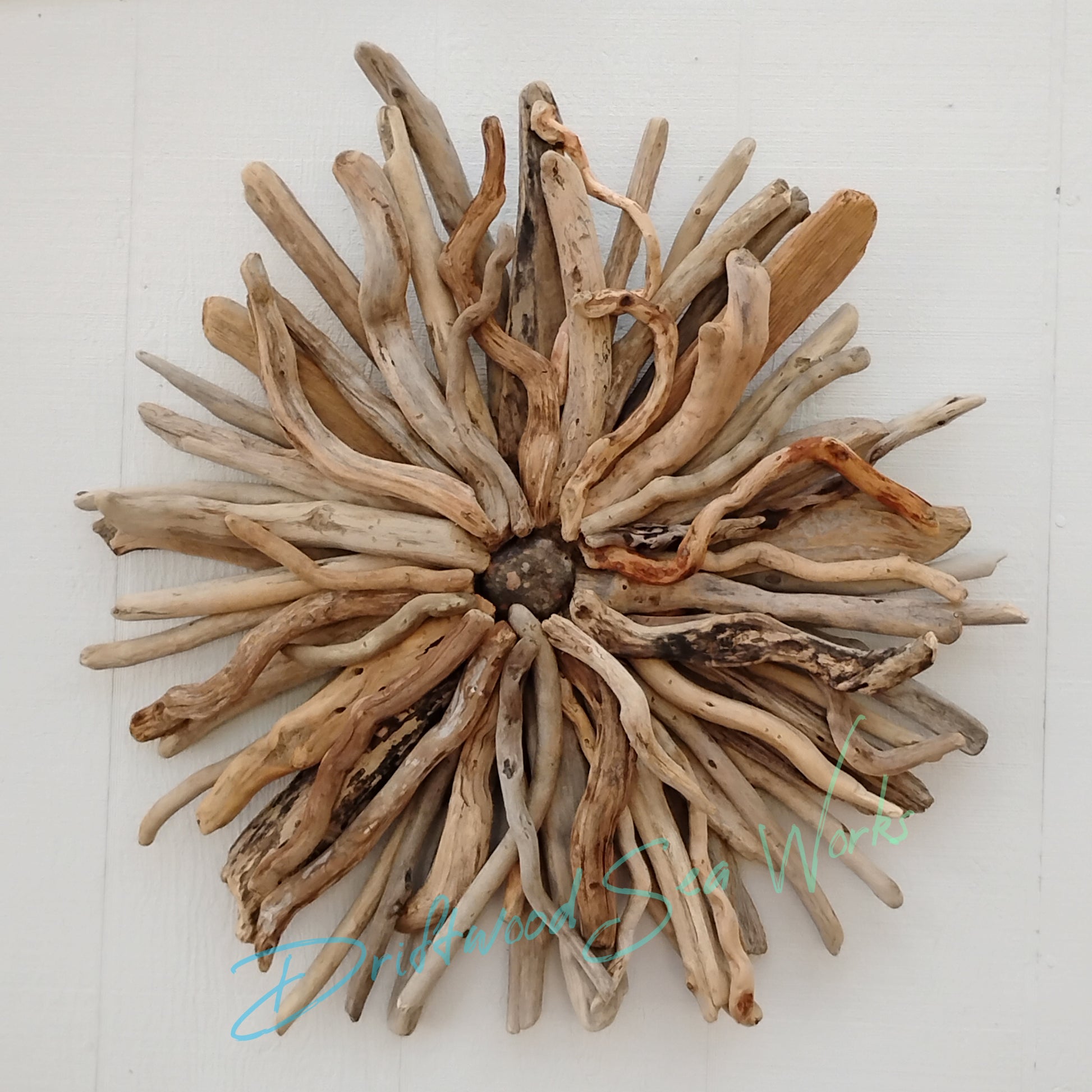 This unique and natural starburst measures 26 x 26 x 5 inches. I made it with driftwood I collected along the beaches of Oregon.
Each Driftwood sculpture is unique and hand made with hand selected driftwood pieces attached one piece at a time using nails for long lasting strength and durability not glue. I have also attached a saw tooth hook on the back for easy hanging as well