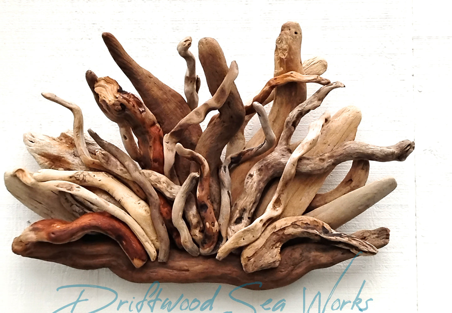Fan shaped abstract driftwood Wall sculpture natural beige and brown in color. Perfect as a fireplace mantel piece of art.