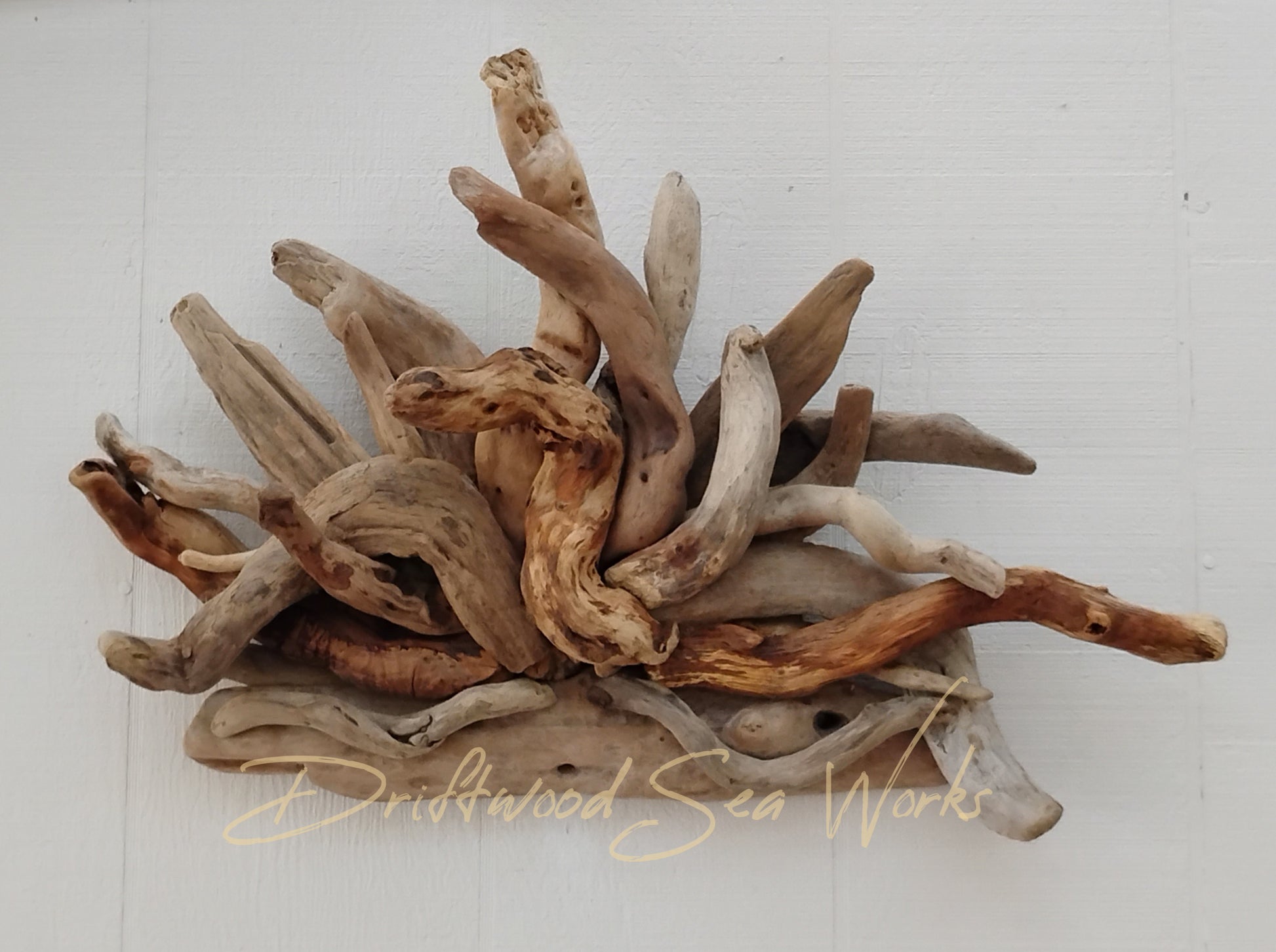 Hang this real driftwood wall sculpture above any entry way to bring a little beach to your home. Maybe it would look great in front of the fireplace when not being used. String some lights through it or wrap plants between the driftwood. However you choose to use this natural driftwood sculpture, it is sure to spark a conversation. This piece measures 25 x 18 inches. I made it with driftwood I collected at the ocean. Each sculpture is unique using hand selected driftwood pieces attached one at a time.