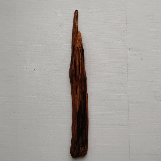 Long thirty four by four in driftwood branch vertical wall hanging that is dark brown in color and varnished to protect the driftwood.