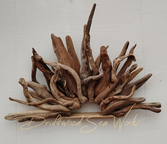 This is a driftwood Wall sculpture that is shaped like a sunrise handmade with a variety of natural sticks from the Oregon Coastline. Neutral earth tone colors and the organic materials make this one of a kind driftwood art sculpture a must have for anyone who loves rustic, natural decor in their favorite spaces.